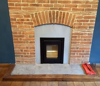 Di Luso R4 Inset Wood Burning Stove - with 3 sided frame in black with bespoke Vlaze fire surround in Basalt fitted by our installers in East Horsley between Guildford and Leatherhead, Surrey.